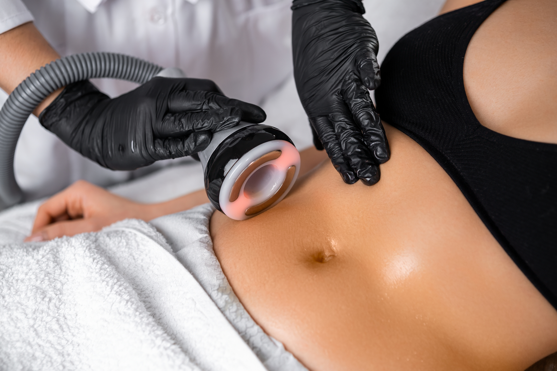 Doctor using an ultrasound body contouring device